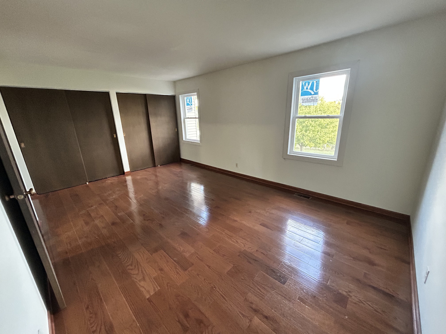 1513 Elder Drive Aurora, IL 60506 - Photo 12 of 26 an empty room with wooden floor and windows
