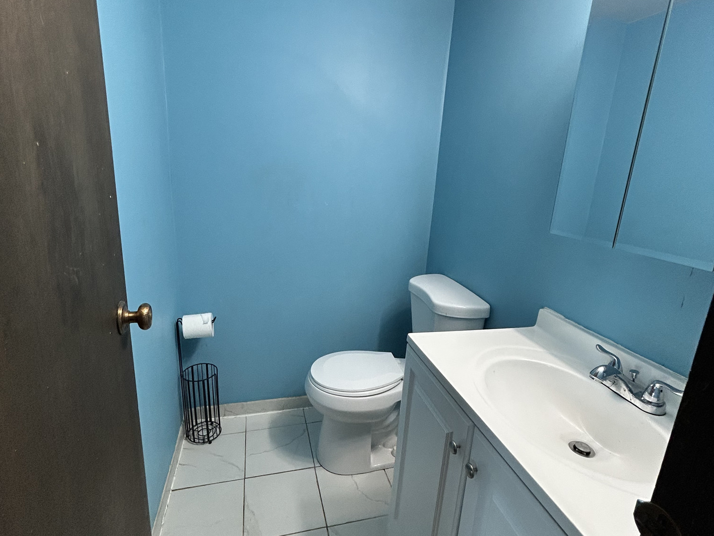 1513 Elder Drive Aurora, IL 60506 - Photo 20 of 26 a white toilet sitting next to a bathroom sink