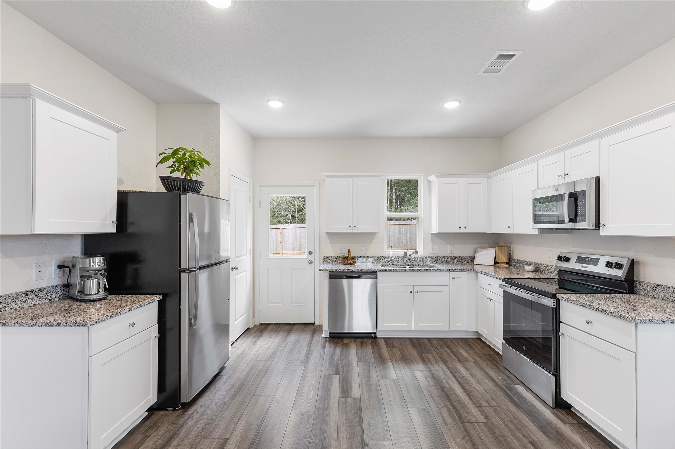 3626 Addington Ct. Huffman, TX 77336 - Photo 12 of 26 a kitchen with a sink stove and refrigerator