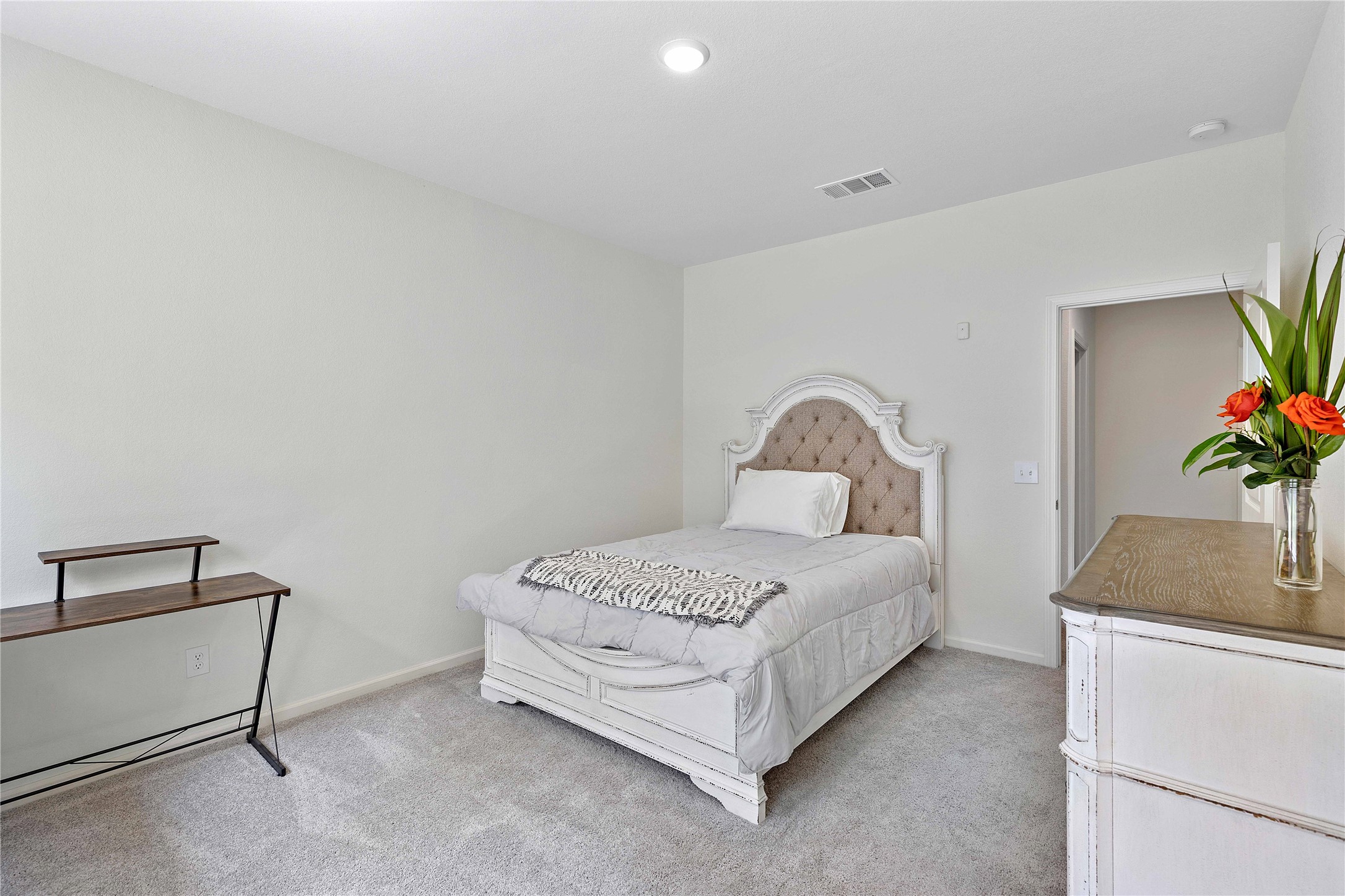 3626 Addington Ct. Huffman, TX 77336 - Photo 15 of 26 a bedroom with a bed and a potted plant