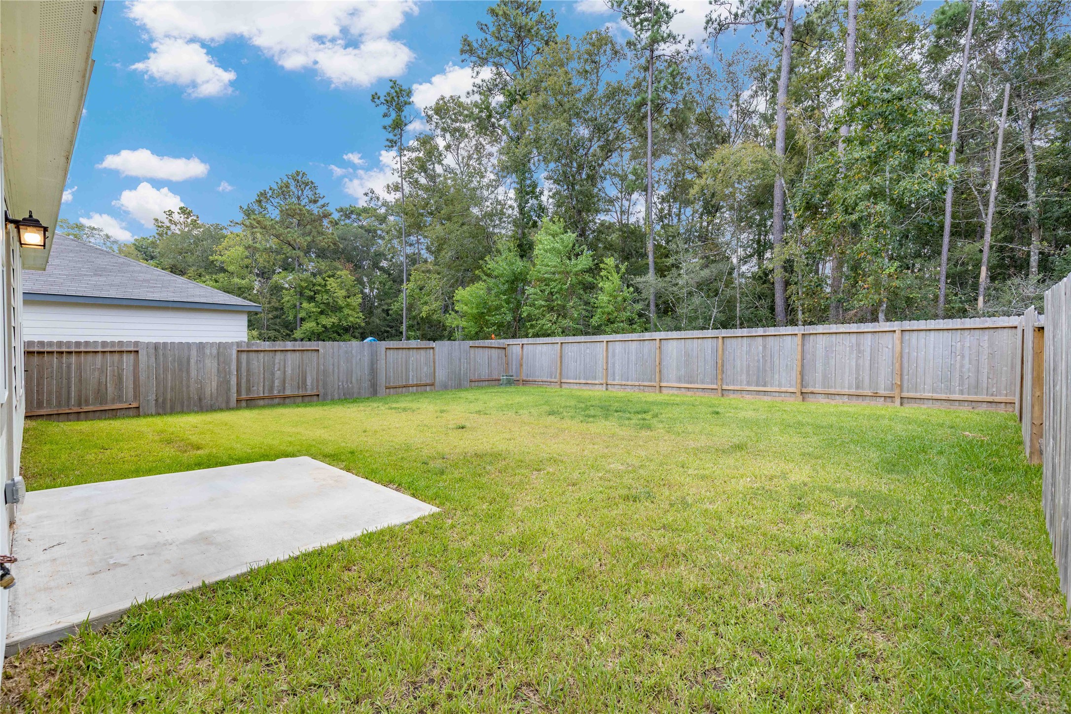 3626 Addington Ct. Huffman, TX 77336 - Photo 26 of 26 a view of a backyard with a garden