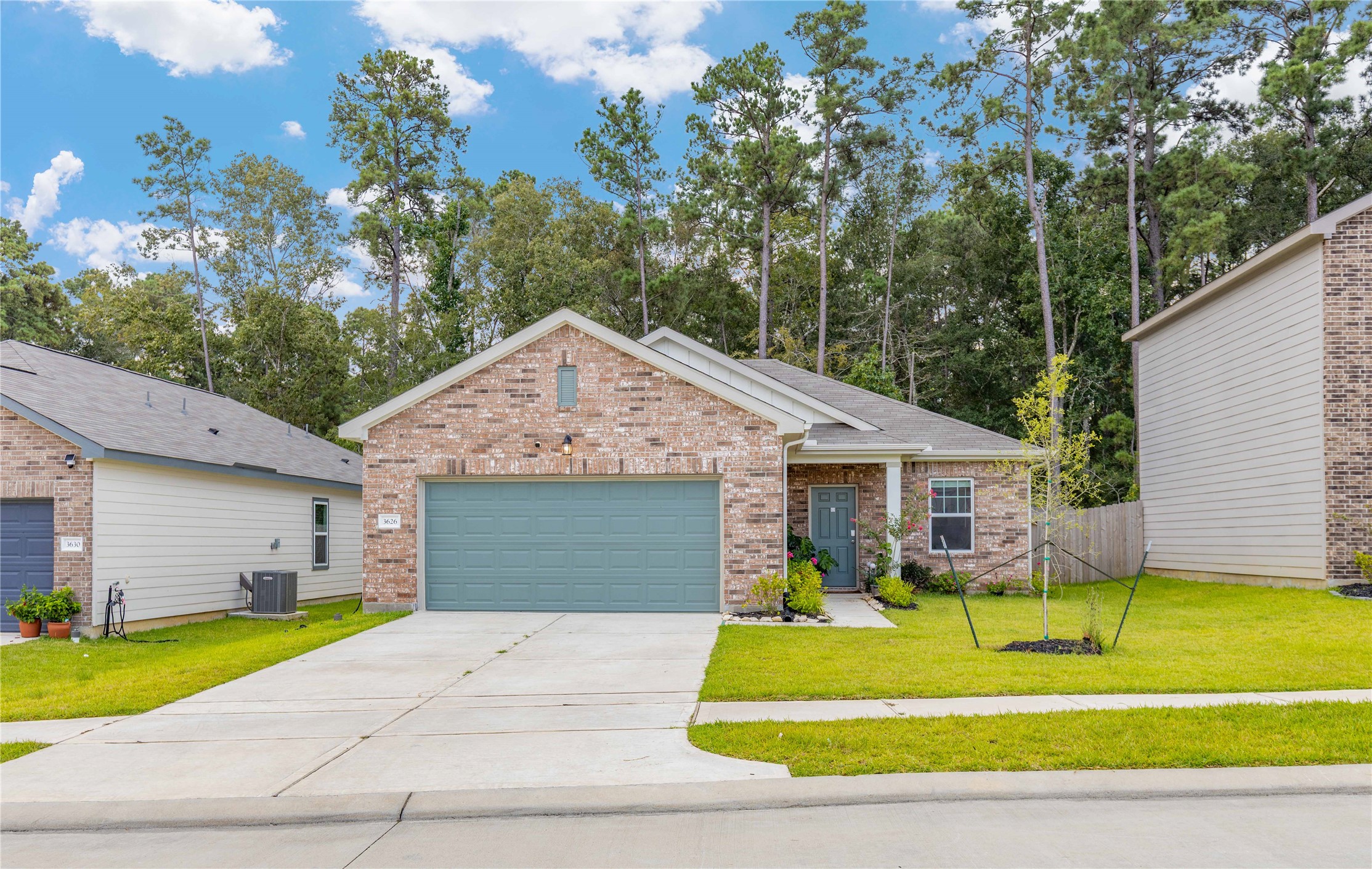 3626 Addington Ct. Huffman, TX 77336 - Photo 3 of 26 a front view of a house with a yard and porch