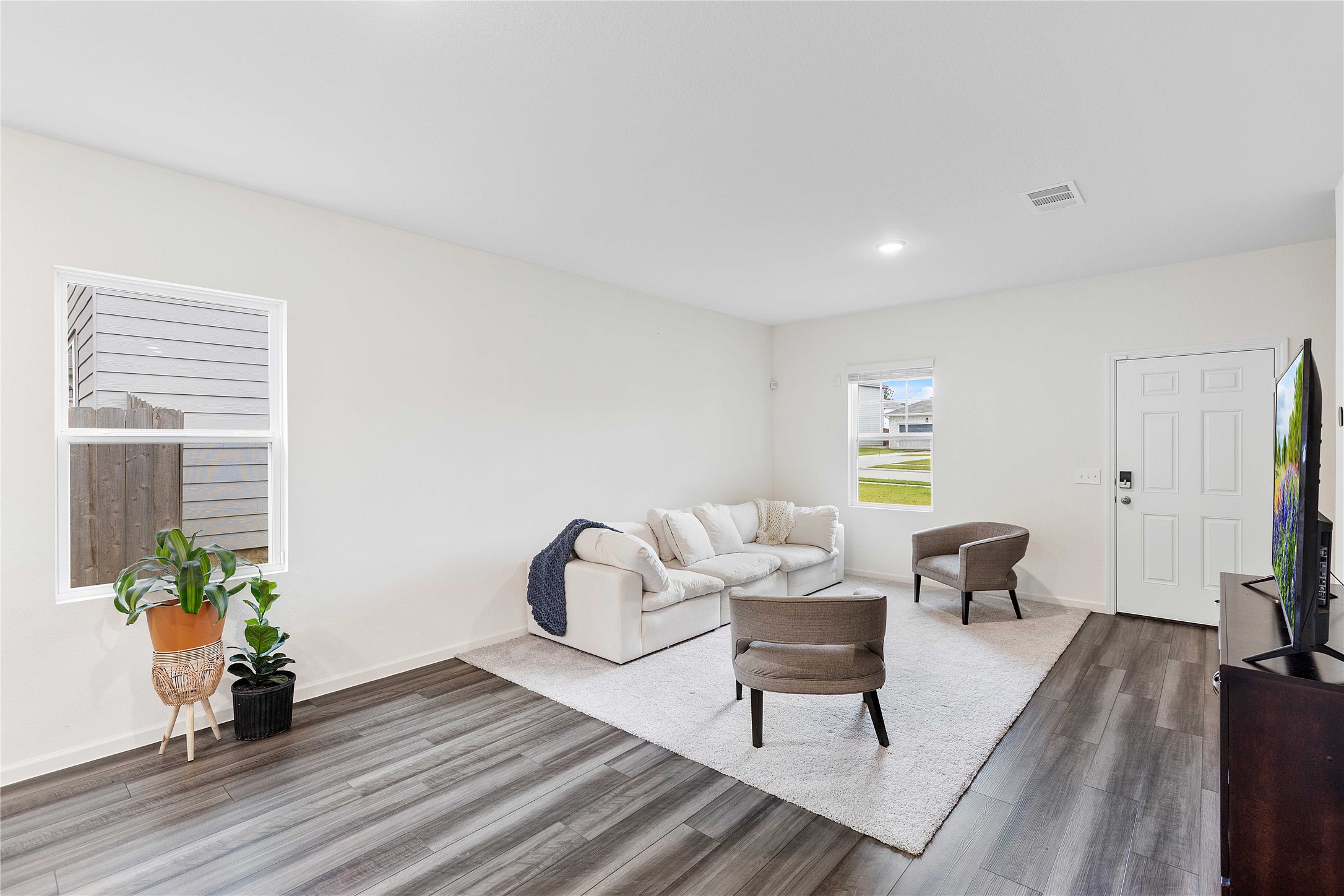3626 Addington Ct. Huffman, TX 77336 - Photo 8 of 26 a living room with furniture a wooden floor and a potted plant