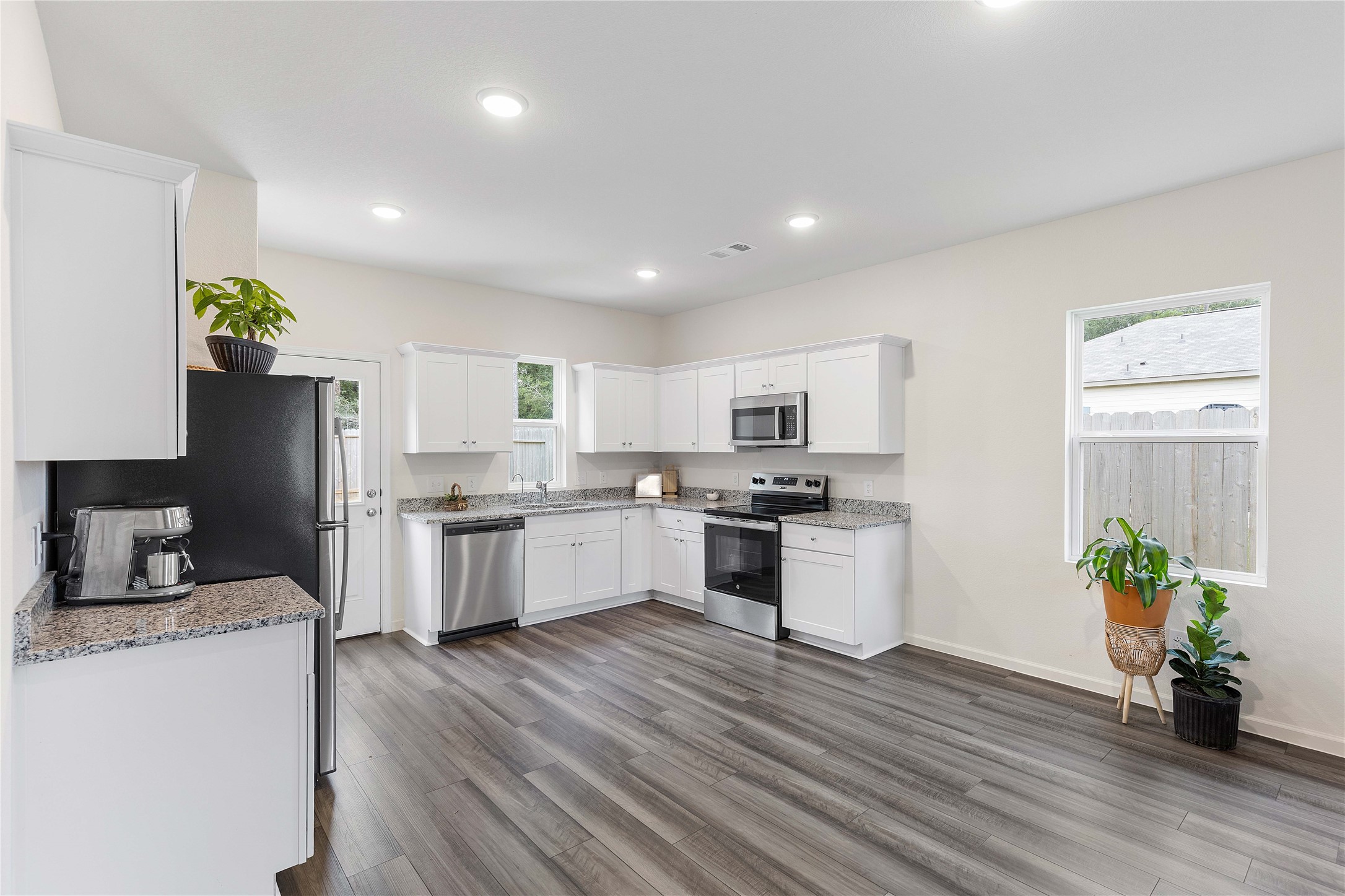 3626 Addington Ct. Huffman, TX 77336 - Photo 9 of 26 a kitchen with a refrigerator and a stove top oven