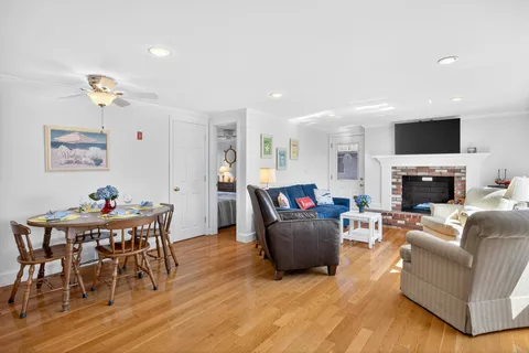 a living room with furniture fireplace and flat screen tv