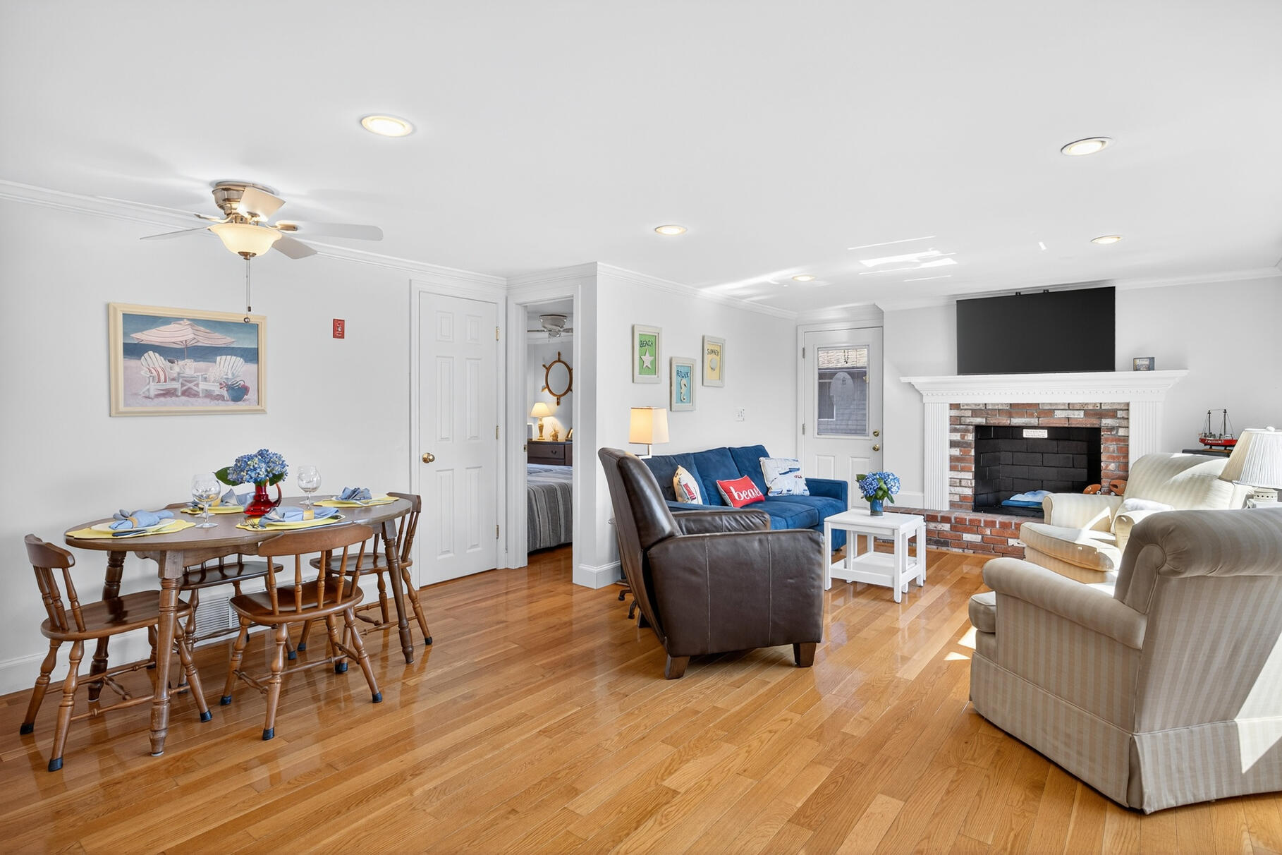35 Shore Drive Mashpee, MA 02649 - Photo 13 of 36 a living room with furniture a fireplace and a flat screen tv