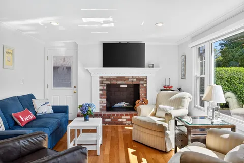 a living room with furniture fireplace and a flat screen tv