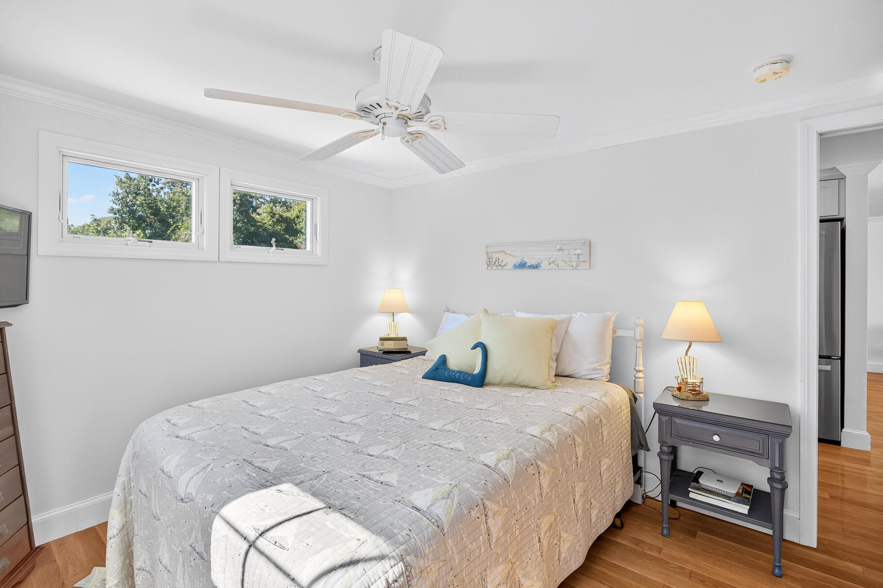 35 Shore Drive Mashpee, MA 02649 - Photo 22 of 36 a bedroom with a bed and a chandelier