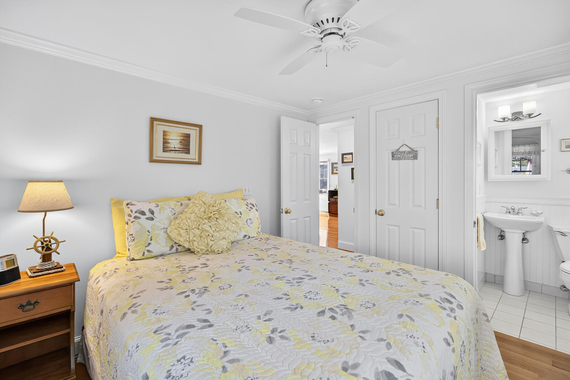 35 Shore Drive Mashpee, MA 02649 - Photo 23 of 36 a bedroom with a bed and a chandelier