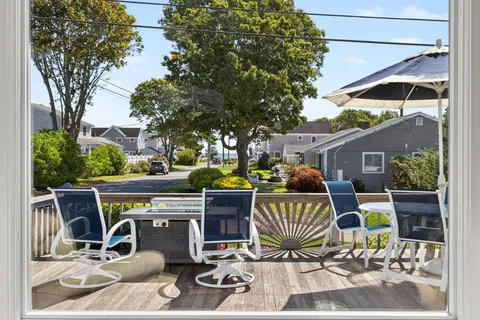 a view of an outdoor sitting area with a table and chair