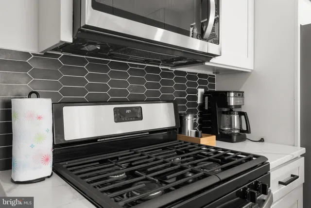 a close view of a stove a microwave and cabinets