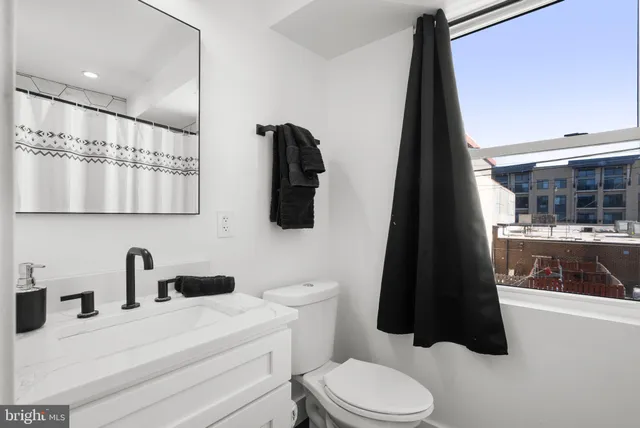 a bedroom with a bed and a dresser in it