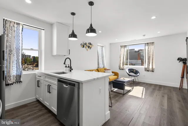 a view of living room with a sink and wooden floor
