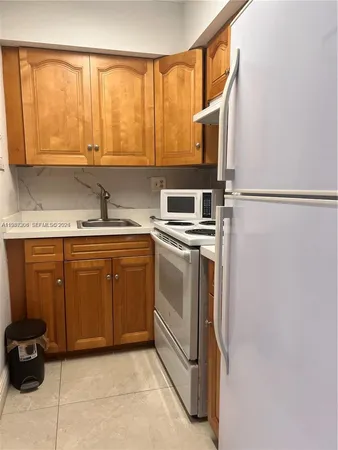 a kitchen with a stove a sink and a refrigerator