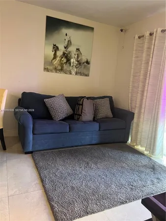 a living room with furniture and a rug