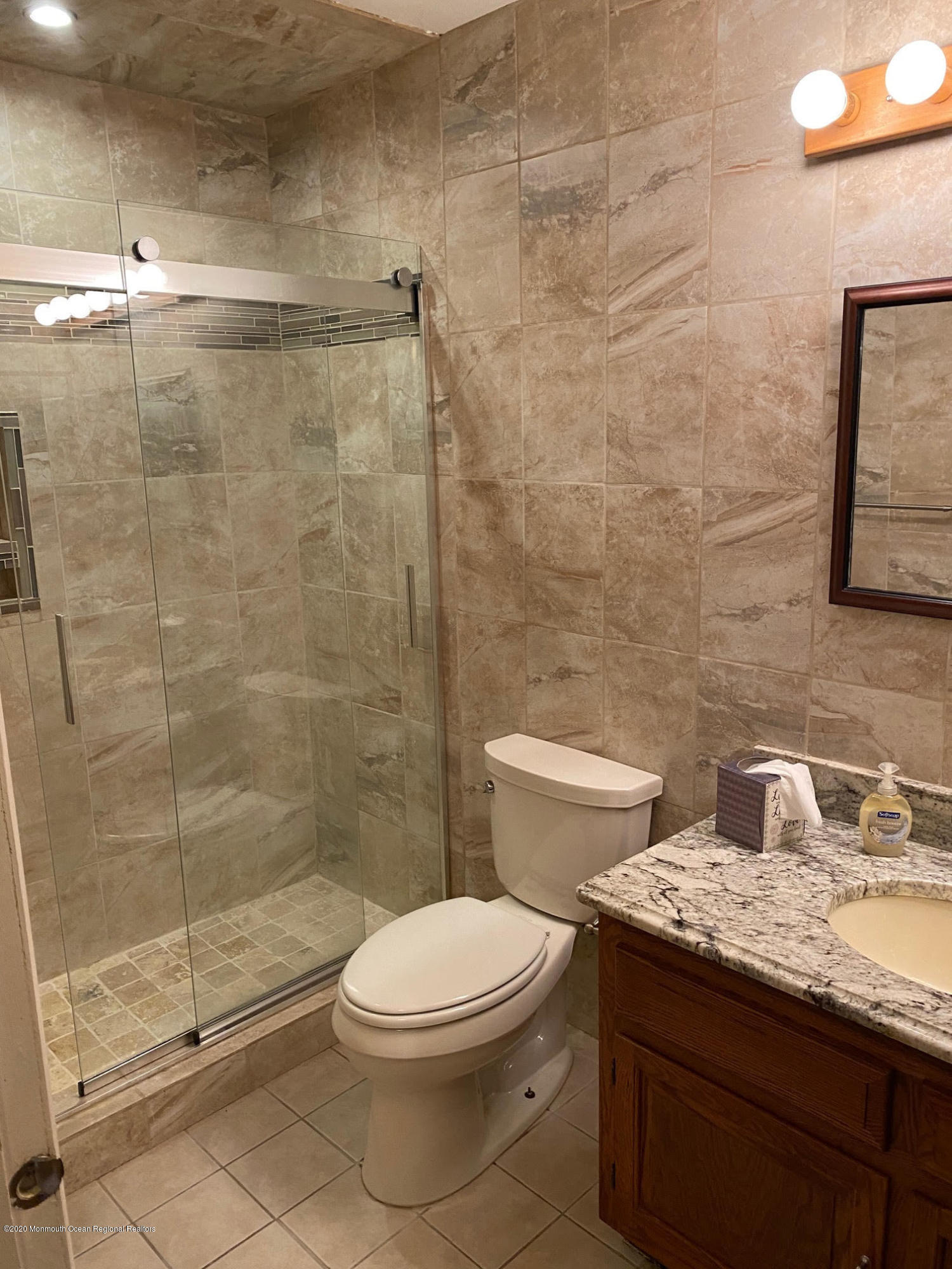 25 A Stonybrook Road Whiting, NJ 08759 - Photo 10 of 13 a bathroom with a granite countertop toilet a sink and shower
