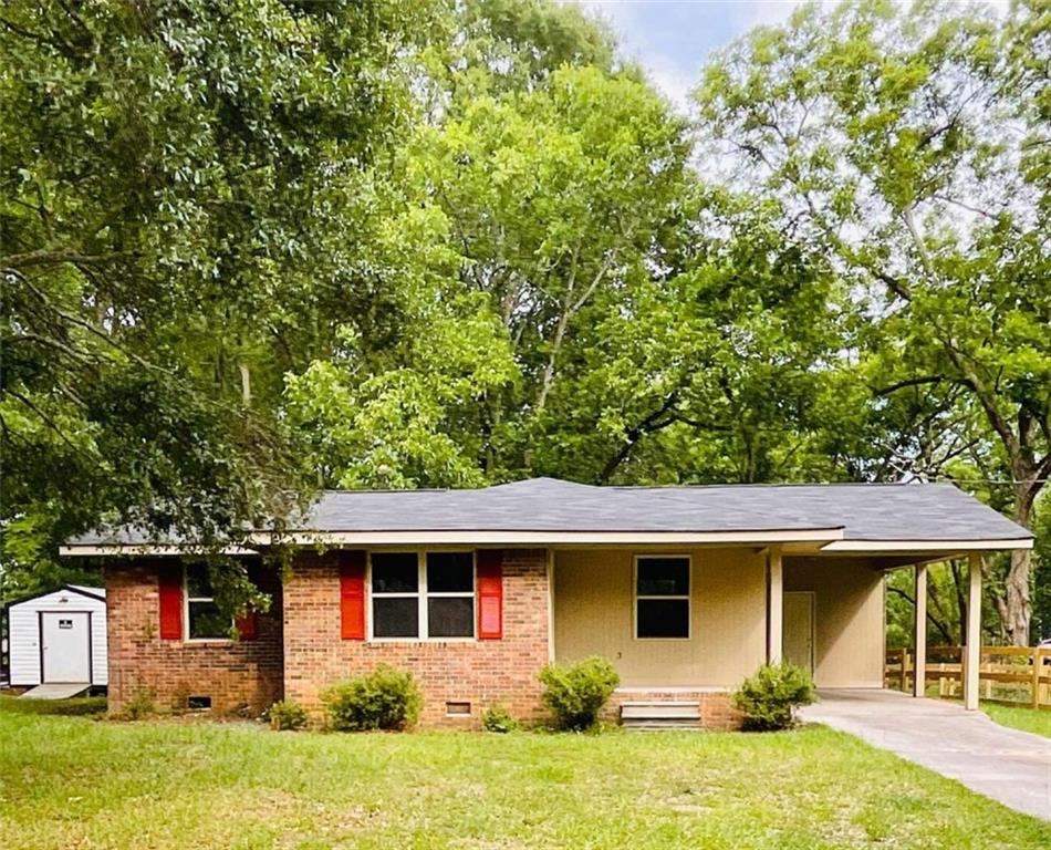 110 Kelly Street Rutledge, GA 30663 - Photo 1 of 1 a front view of house with yard and trees in the background