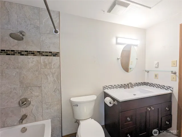 a bathroom with a sink toilet a mirror and shower