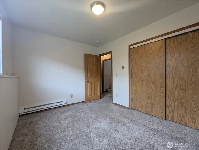 an empty room with closet area