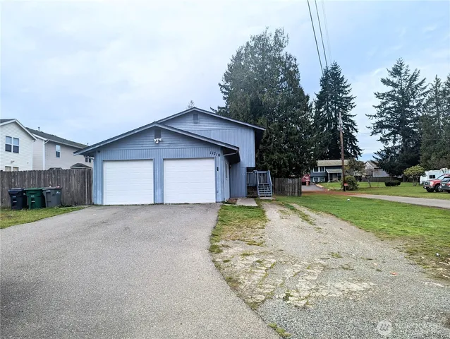 a view of a house with a yard and garage