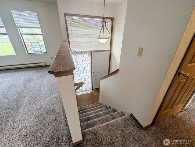 a view of entryway and hall with wooden floor