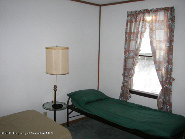 0 Cottrell Road Union Dale, PA 18470 - Photo 6 of 8 a bedroom with a bed and a window