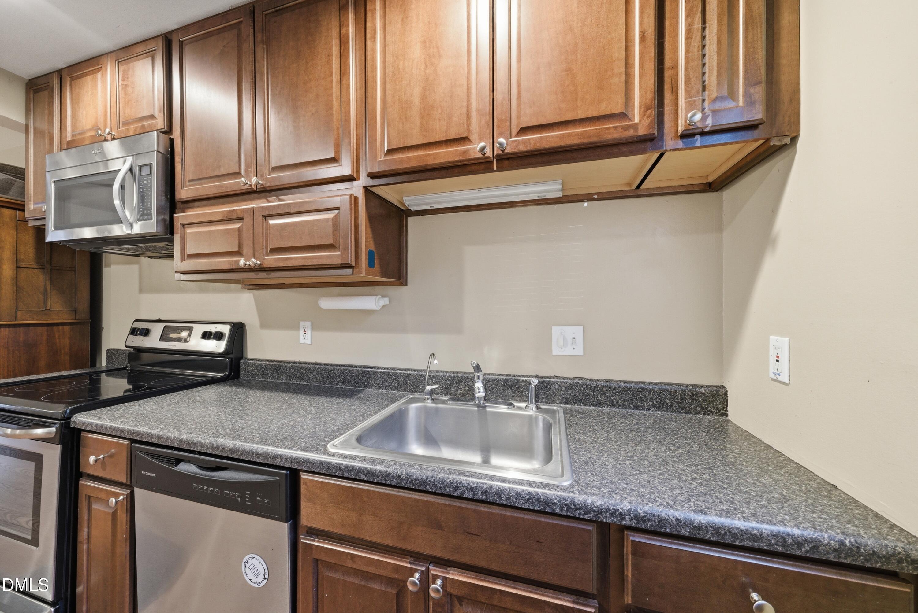 6355 New Market Way Raleigh, NC 27615 - Photo 12 of 30 a kitchen with granite countertop stainless steel appliances a sink and cabinets