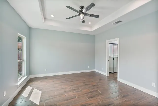 wooden floor in an empty room with a window