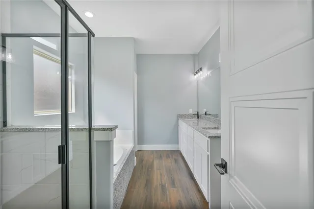 a bathroom with a double vanity sink and mirror