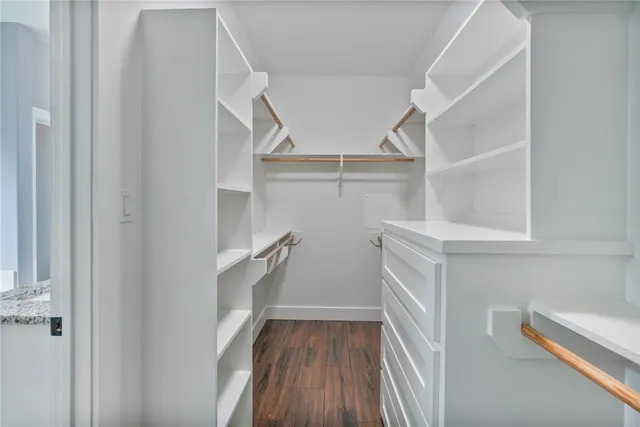 a view of walk in closet with empty racks