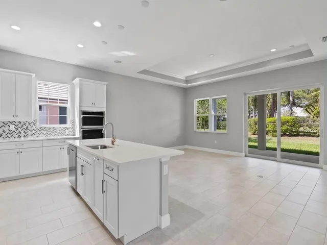 a kitchen with a stove a sink a microwave and a counter top space