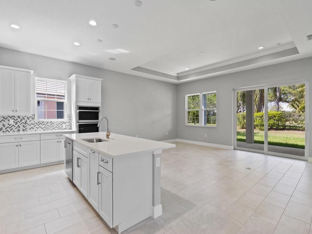 1891 East Cayman Road Vero Beach, FL 32963 - Photo 13 of 27 a kitchen with a stove a sink a microwave and a counter top space