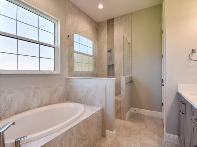 a bath tub sitting in a bathroom next to a window