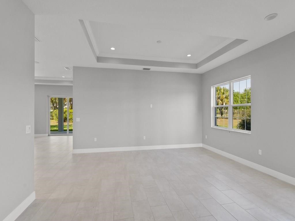 1891 East Cayman Road Vero Beach, FL 32963 - Photo 5 of 27 wooden floor in an empty room with a window