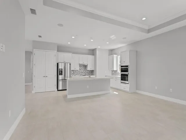 a view of kitchen and refrigerator in a room