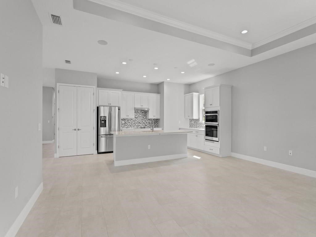 1891 East Cayman Road Vero Beach, FL 32963 - Photo 8 of 27 a view of kitchen and refrigerator in a room