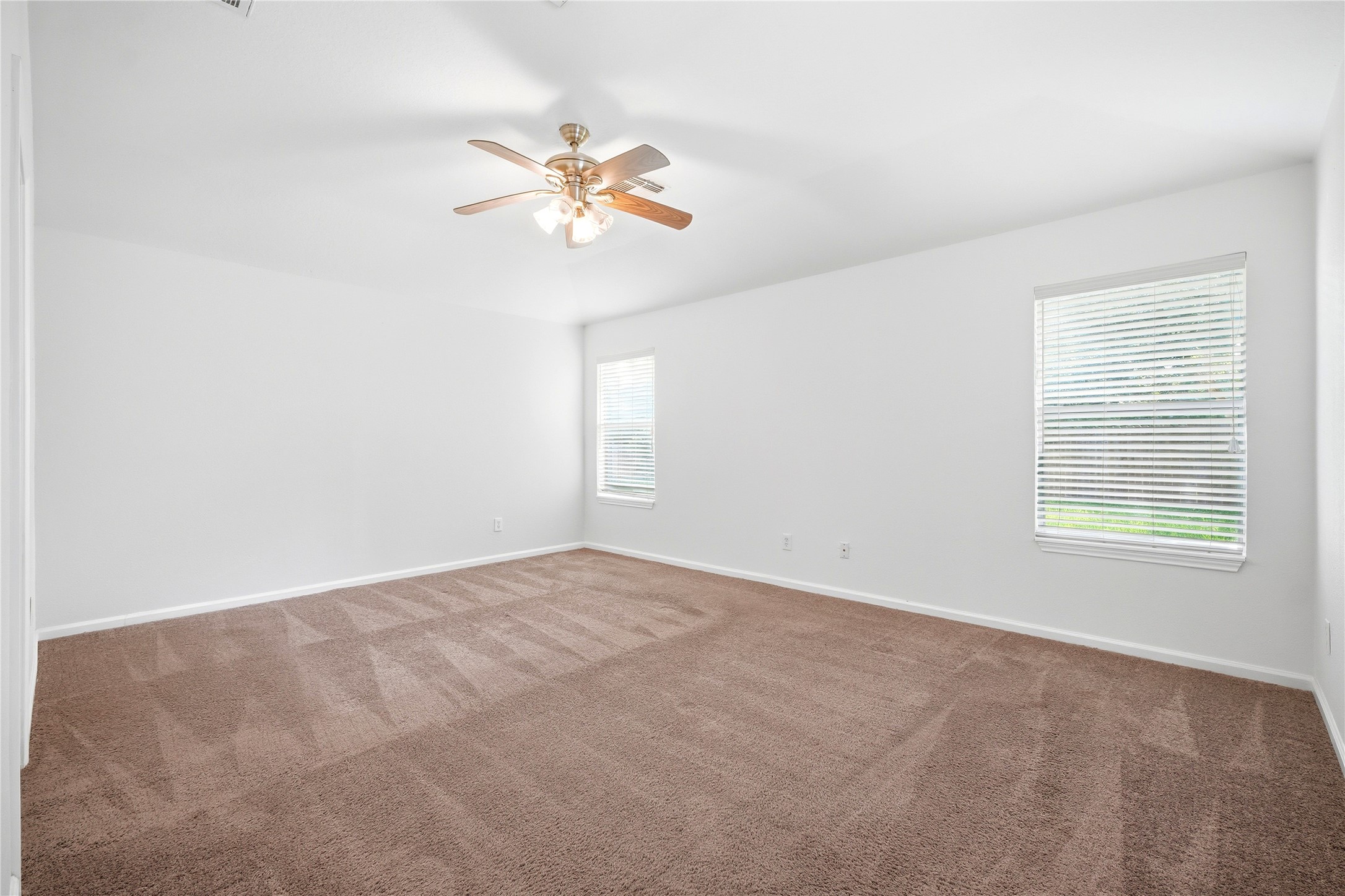 5411 Gate Canyon Court Spring, TX 77373 - Photo 17 of 33 a view of an empty room with chandelier fan and a window
