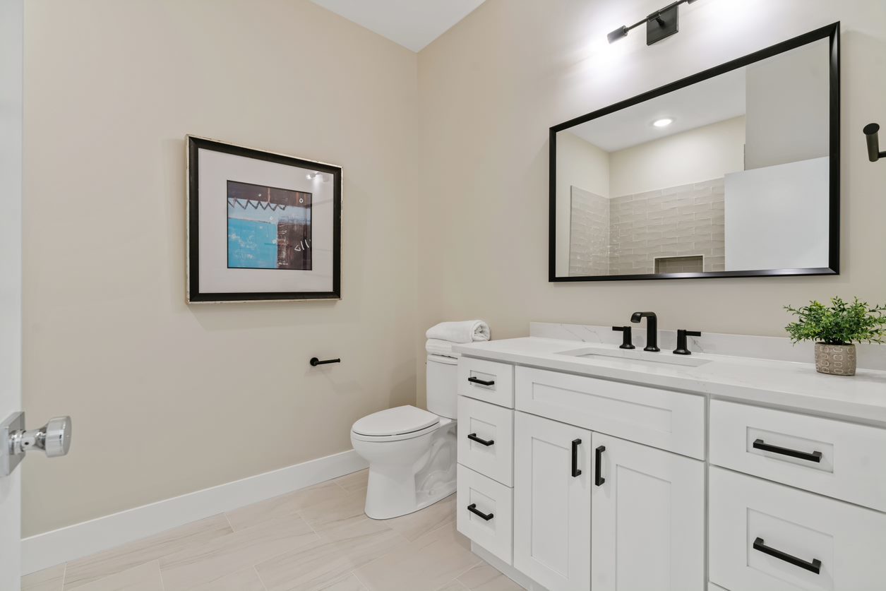 Undisclosed Address Chicago, IL 60657 - Photo 17 of 22 a bathroom with a toilet sink vanity and mirror