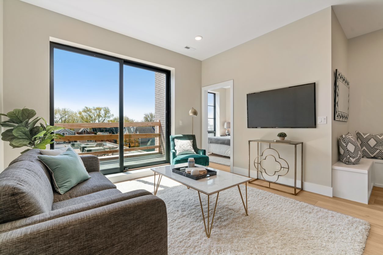 Undisclosed Address Chicago, IL 60657 - Photo 2 of 22 a living room with furniture a flat screen tv and a floor to ceiling window