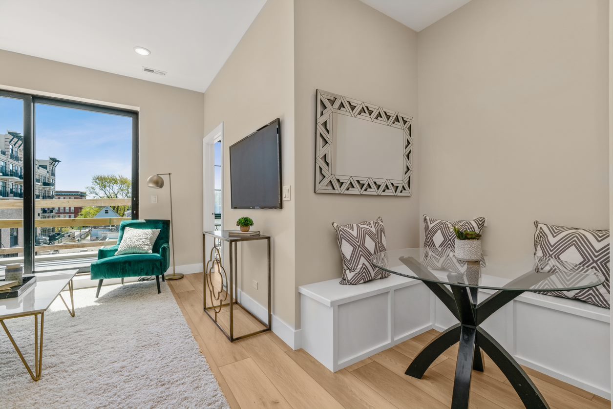 Undisclosed Address Chicago, IL 60657 - Photo 6 of 22 a living room with furniture a flat screen tv and a floor to ceiling window