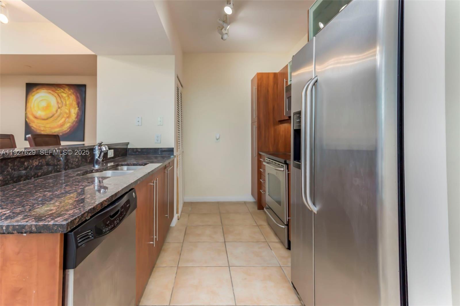 7355 Southwest 89th Street, Unit 721N Miami, FL 33156 - Photo 2 of 29 a kitchen with stainless steel appliances granite countertop a refrigerator and a sink