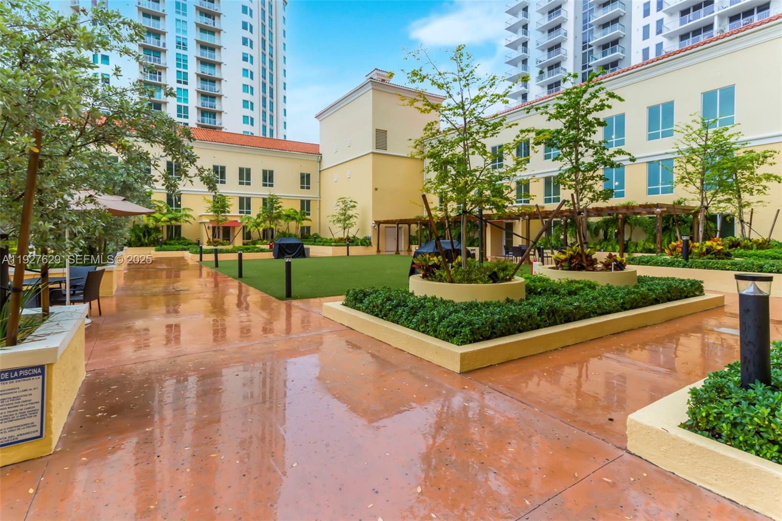 7355 Southwest 89th Street, Unit 721N Miami, FL 33156 - Photo 22 of 29 a view of a white building with a yard