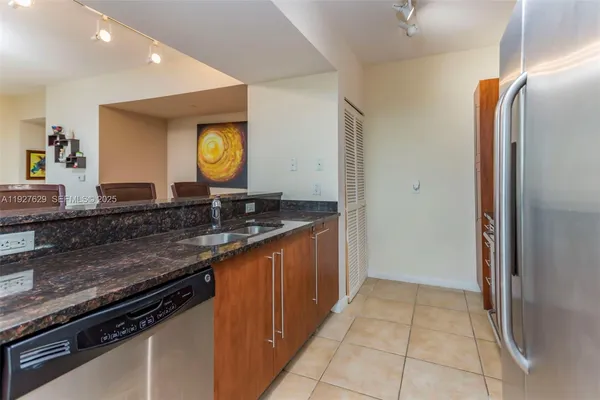 a kitchen with stainless steel appliances granite countertop a sink stove and cabinets