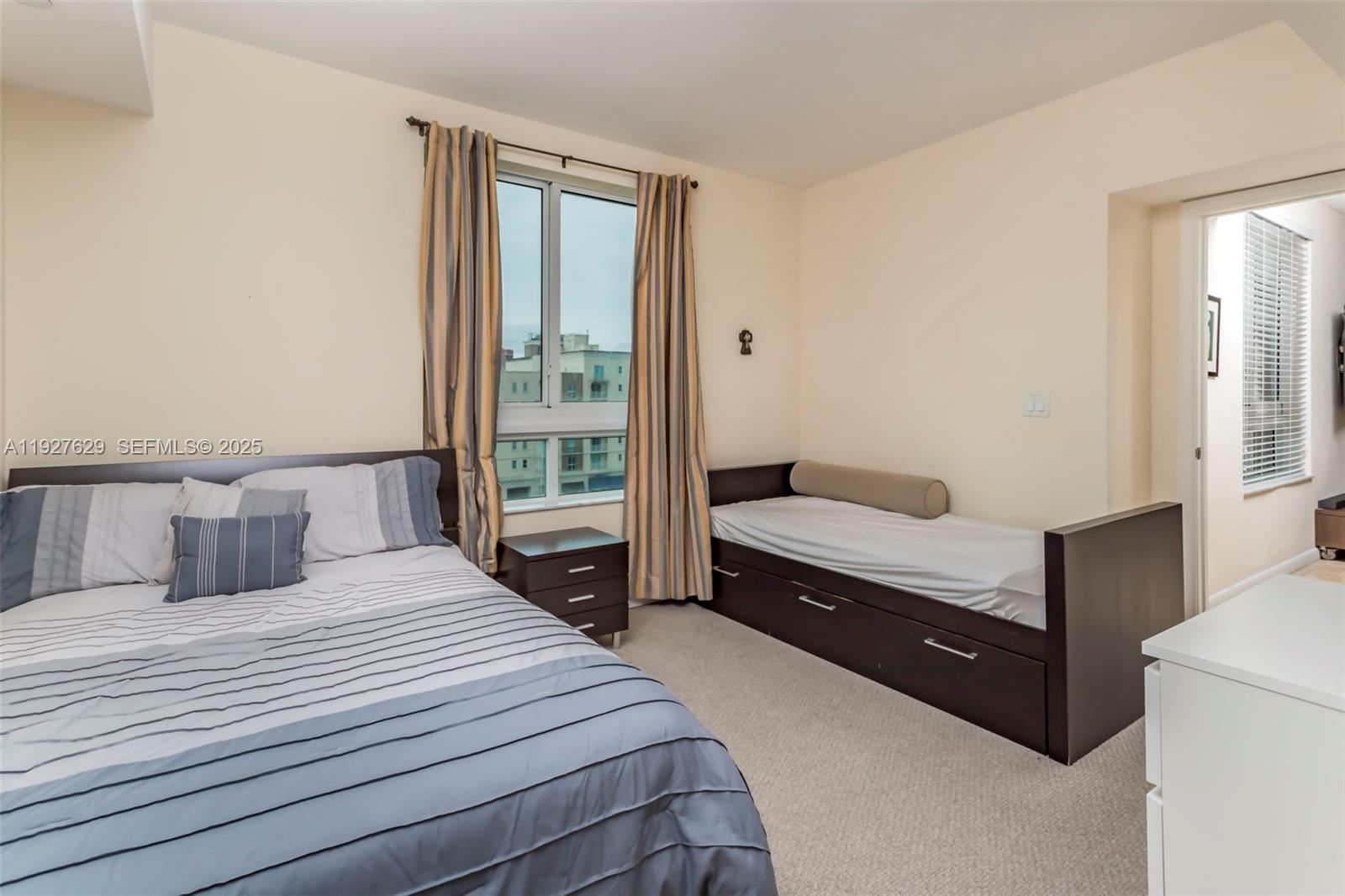 7355 Southwest 89th Street, Unit 721N Miami, FL 33156 - Photo 10 of 29 a bedroom with a bed and a window