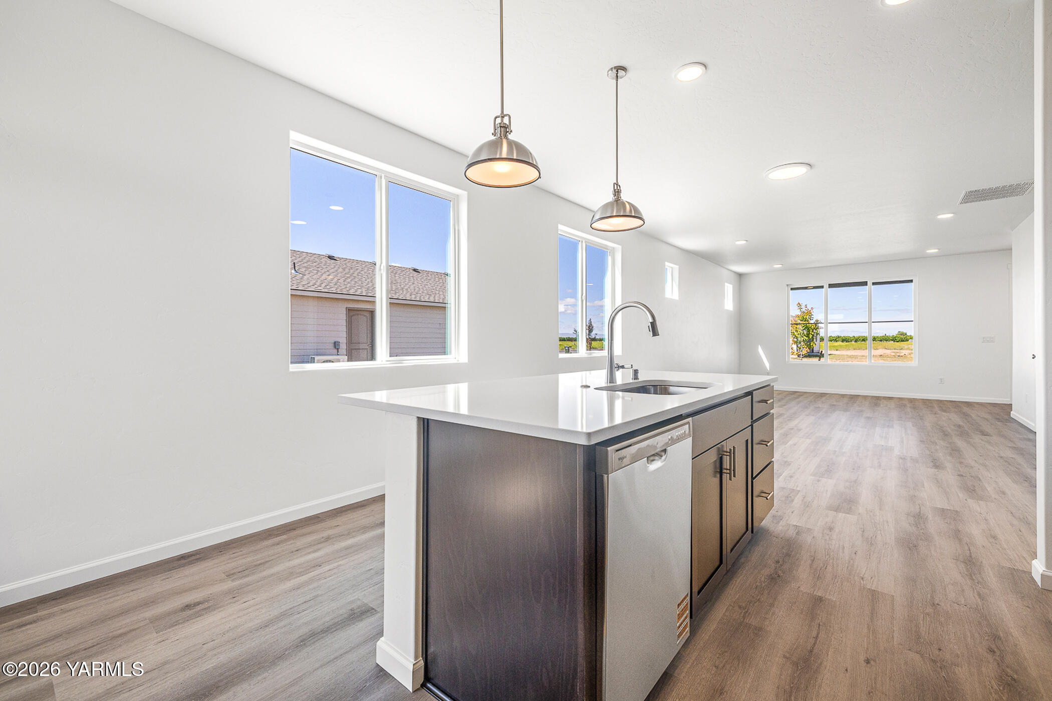 1603 Diamond Avenue Grandview, WA 98930 - Photo 19 of 32 a kitchen with granite countertop a sink cabinets and wooden floor