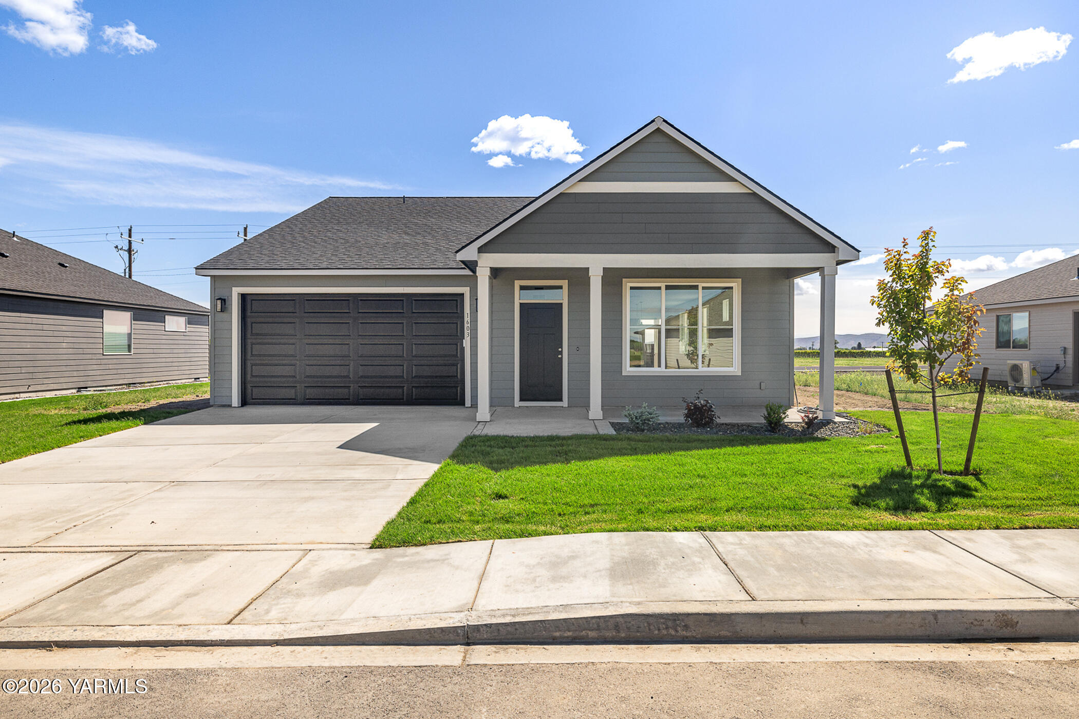 1603 Diamond Avenue Grandview, WA 98930 - Photo 20 of 32 a front view of a house with a yard and garage