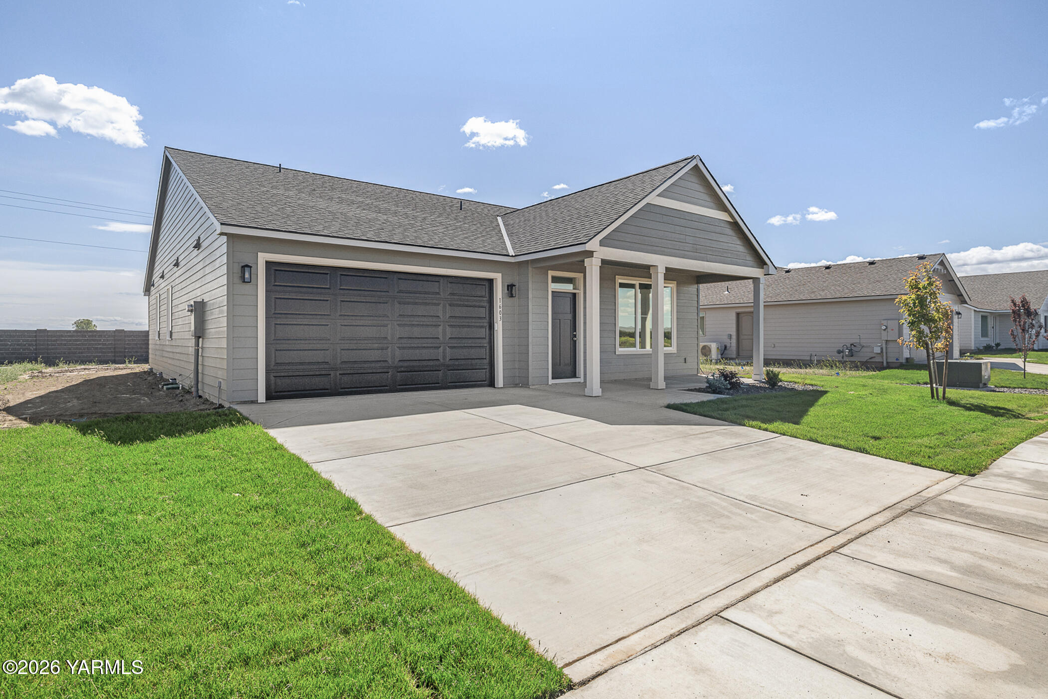 1603 Diamond Avenue Grandview, WA 98930 - Photo 21 of 32 a front view of a house with a yard and garage
