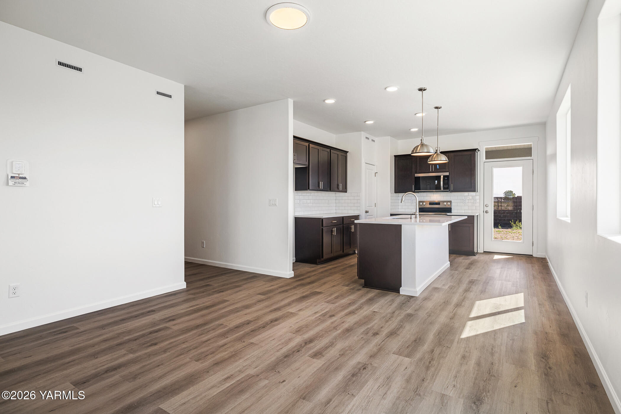 1603 Diamond Avenue Grandview, WA 98930 - Photo 6 of 32 a view of kitchen with microwave refrigerator and cabinets