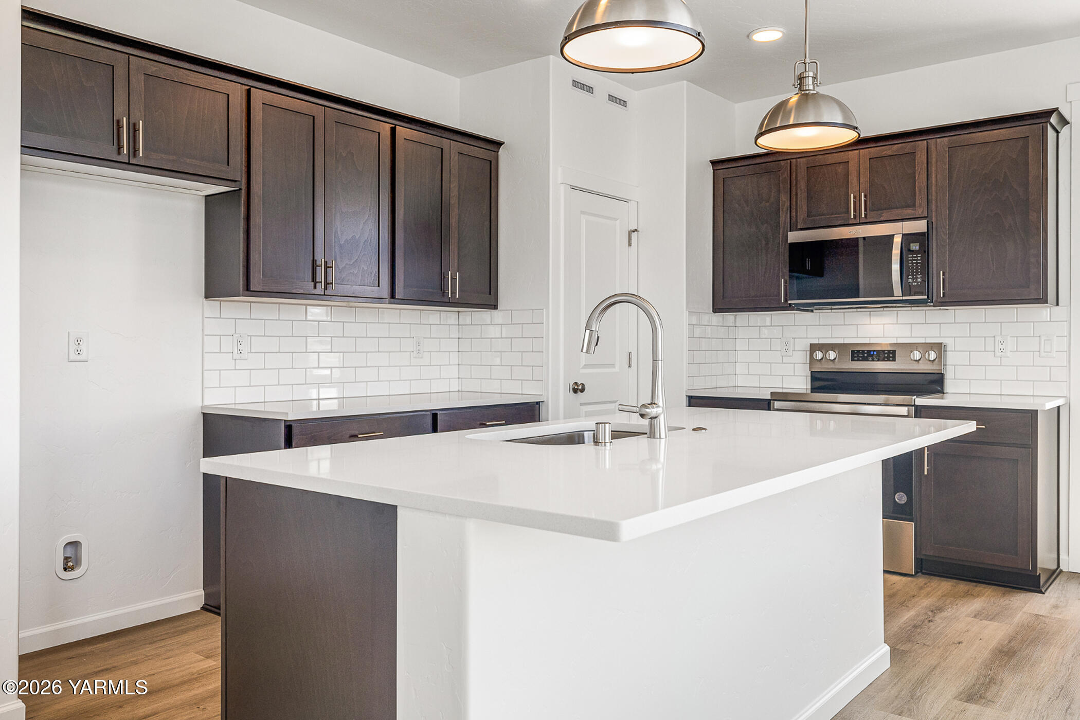 1603 Diamond Avenue Grandview, WA 98930 - Photo 8 of 32 a kitchen with stainless steel appliances a sink a stove a microwave and cabinets