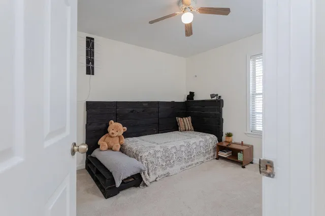 a bedroom with bed and window